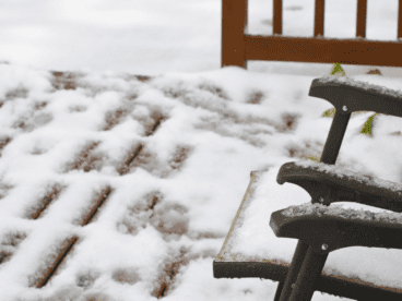 composite decking covered in a layer of wet snow